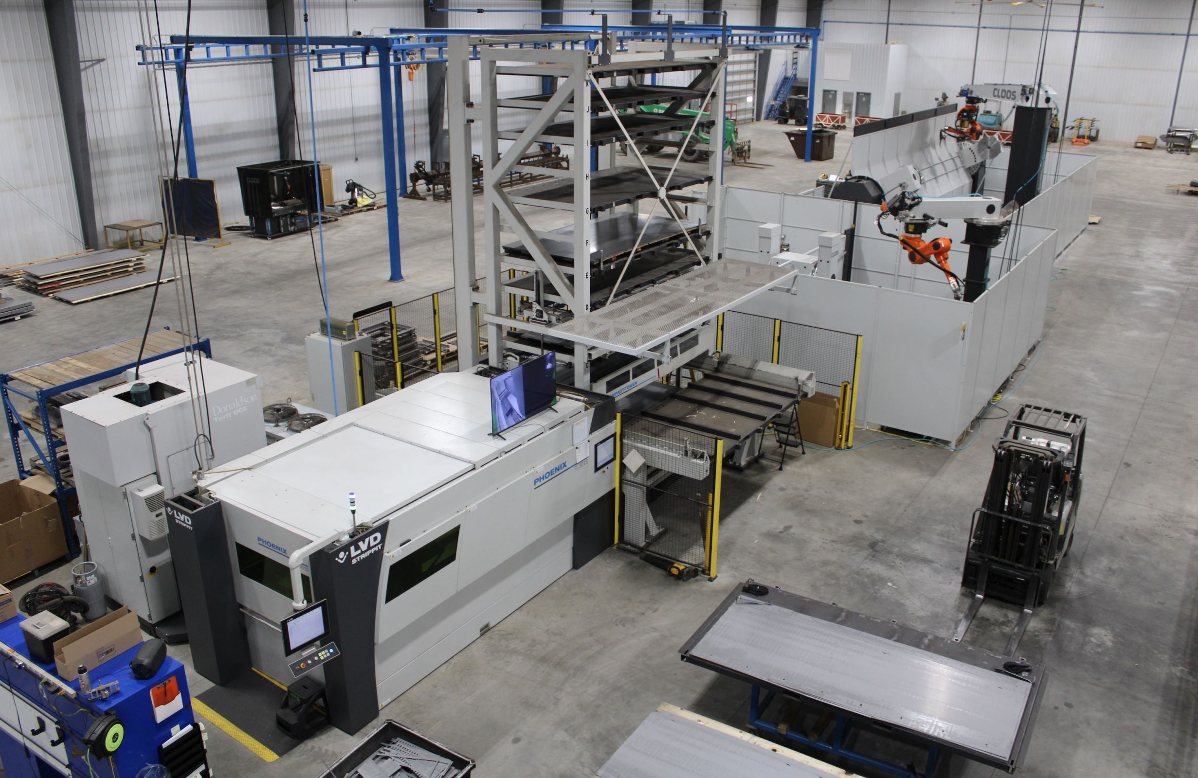 high up wide view of the production floor with many  machines 