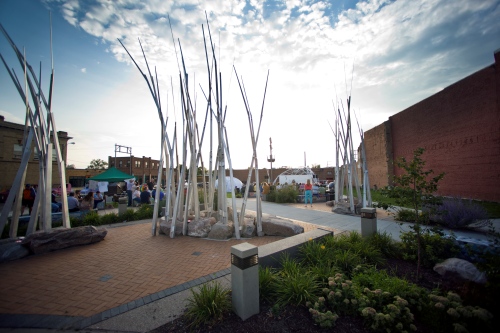 public space with tall, thin white trunks clumped together as if building a teepee